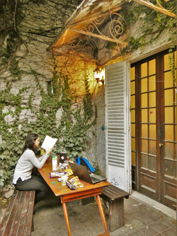 Patio of Casa Ombú with a wooden table under the trees